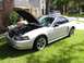 2002 Ford Mustang - Silver 2002 Ford Mustang convertible parked on grass with the hood open.