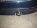 1993 Ford Taurus - Close-up of a dark blue car's rear bumper and exhaust pipe, with a Supermotors.com logo visible.