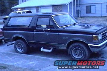 1989 Ford Bronco parked outside a building