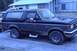 1989 Ford Bronco - This 1989 Ford Bronco is parked on a paved surface in front of a building.