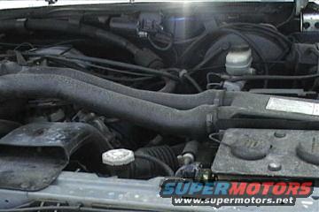 1989 Ford Bronco engine bay with hoses and master cylinder visible