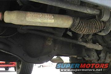 Vehicle undercarriage with a shock absorber labeled TRAIL