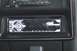 1989 Ford Bronco - Close-up of a car stereo unit, the SuperMotors website address at the bottom.