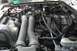 1989 Ford Bronco - Close-up view of a vehicle's engine compartment, showing various components and hoses.