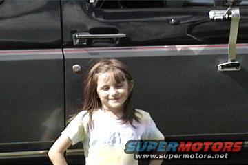 Dark SUV side view with a young girl in front