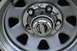 1989 Ford Bronco - A close-up view of a vehicle's wheel hubcap, the SuperMotors website logo at the bottom.