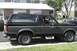 1989 Ford Bronco - Side profile of a two-tone gray and black 1987-1991 Ford Bronco, a spare tire on the rear.