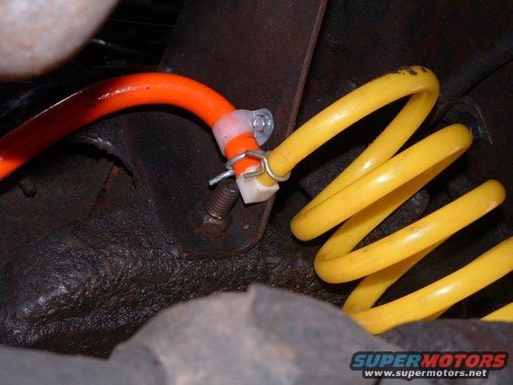 Orange and yellow hoses secured with clips in an engine bay