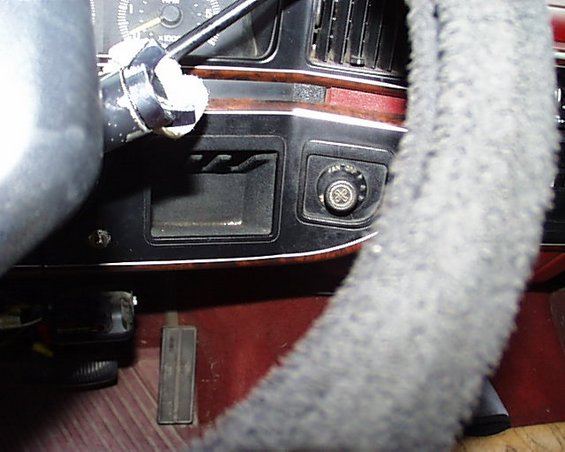 1988 Ford C-350 (Centurion Conversions) interior with fuzzy gray steering wheel cover, wood trim dashboard, and air vents