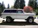 1980 Jeep Liberty - Side view of a lifted 1980 Jeep Wagoneer, showing its off-road tires and pinstripe detail.