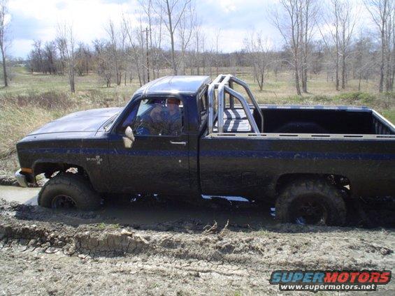 picture-051.jpg and he gets pretty stuck.  Bottomed out on both axles with opposite wheels spinning