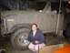 1981 Ford Bronco - A woman poses in front of a heavily mud-caked 1981 Ford Bronco, likely after off-roading.