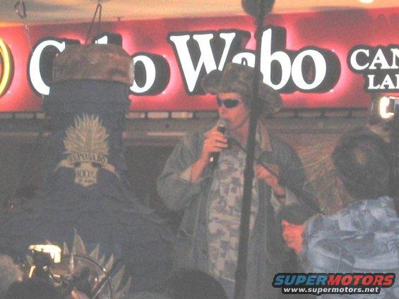 Man in cowboy hat singing into microphone at Cabo Wabo