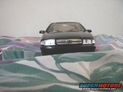 black sedan model on a patterned surface