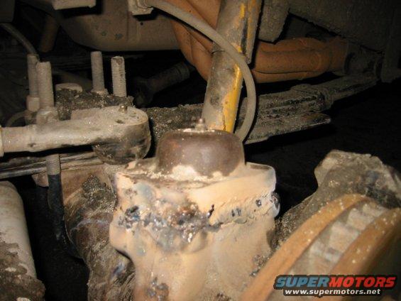 1070783_img.jpg friend's 1 ton chevy broke the upper Kin pin cap. sheared the bolts right off so i welded it back on :)