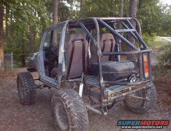 Off-road Suzuki Samurai with roll cage and large tires, rear view