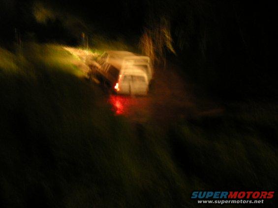 White van with red taillights, seen from rear at night