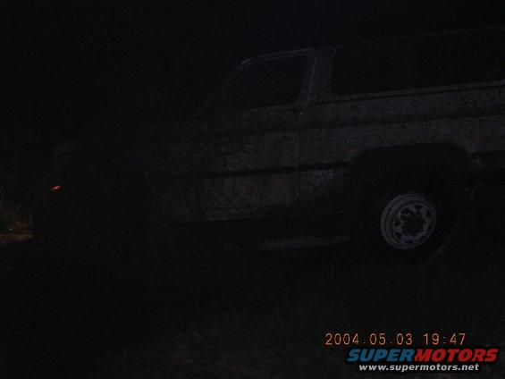 Side view of a dark SUV with a visible wheel and a timestamp