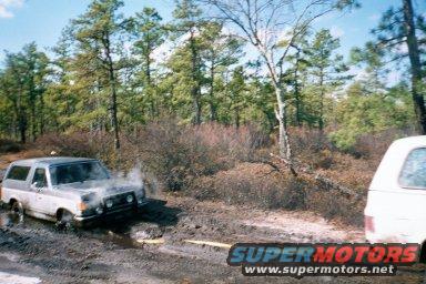 1978 Ford Bronco stuck in mud, another vehicle to the right