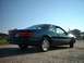 1996 Ford Thunderbird - The rear view of a dark blue coupe shows its taillights and license plate under a bright sky.