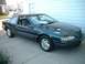 1996 Ford Thunderbird - Dark green 1996 Ford Thunderbird coupe parked on a driveway.