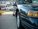 1996 Ford Thunderbird - Front corner view of a dark green 1996 Ford Thunderbird parked on a driveway.