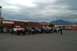 1992 Ford F-150 - A group of off-road vehicles are gathered in a parking lot under a cloudy sky.