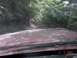 1992 Ford F-150 - Driving on a muddy trail through dense woods with another vehicle ahead.