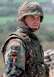 1997 Ford Expedition - A soldier wears a camouflage uniform adorned with an American flag patch and a patch reading "Doing the Work of" above several other nation…