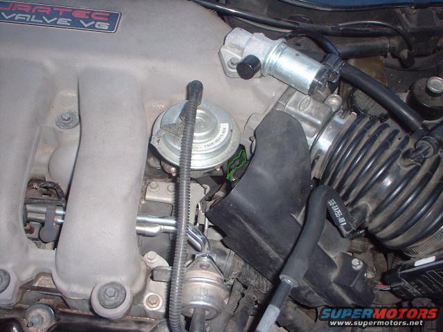 Close-up of engine components including intake manifold, throttle body, and EGR valve