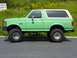 1990 Ford Bronco - This lifted 1990 Ford Bronco is seen from the side, a two-tone green and white paint scheme.