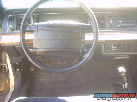 1991 Ford Crown Victoria interior showing steering wheel, dashboard, and gear shifter