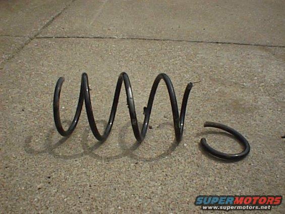 broken coil spring on concrete