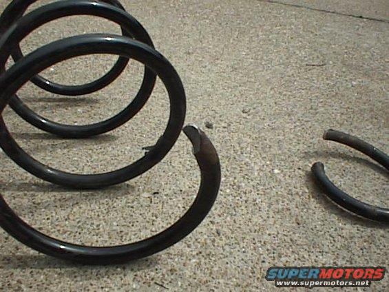 Broken coil spring on concrete surface