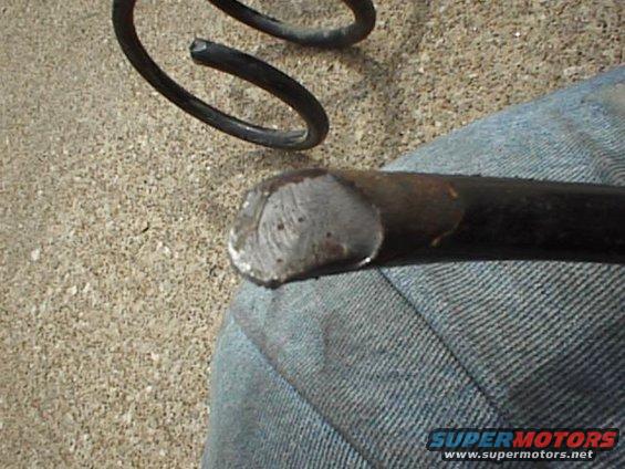 Close-up of a broken metal spring and its end