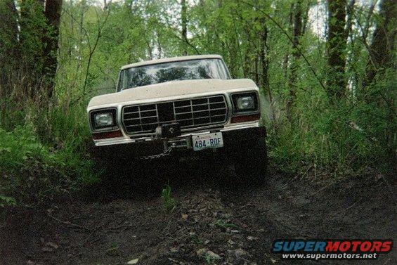 1978 Ford Bronco on muddy trail, front view, with winch