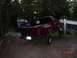 1992 Ford F-150 - A red pickup truck is parked in a yard with a dark colored SUV behind it.