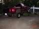 1992 Ford F-150 - A red 1992 Ford F-150 pickup truck is positioned on ramps, with its front wheels elevated.