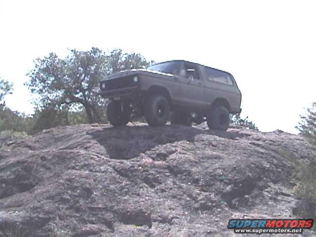 1978 Ford Bronco on a rocky incline, viewed from the front-right
