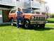 1986 Ford Bronco - A man poses with his vintage Ford Bronco parked on a grassy lawn in front of an apartment building.