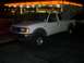 2000 Ford F-450 - A white Ford Ranger pickup truck is parked at a gas station at night.
