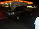 2000 Ford F-450 - This 2000 Ford F-450 pickup truck is parked at a gas station at night.