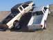 2000 Ford F-450 - Two pickup trucks, a gold Ford F-450 and a white truck, navigate a sandy hill with modified suspensions.