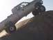 2000 Ford F-450 - Modified 2000 Ford F-450 pickup truck navigates a steep dirt incline.
