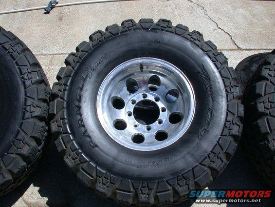 Off-road tires with polished aluminum rims, some text visible on sidewalls