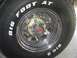 1979 Ford Bronco - A close-up view of a vehicle's chrome wheel and tire, raised white lettering.