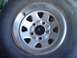 1979 Ford Bronco - A close-up view of a BFGoodrich tire mounted on a silver wheel.