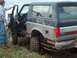 1979 Ford Bronco - A muddy 1979 Ford Bronco is stuck in the dirt, with one person entering the driver's side.