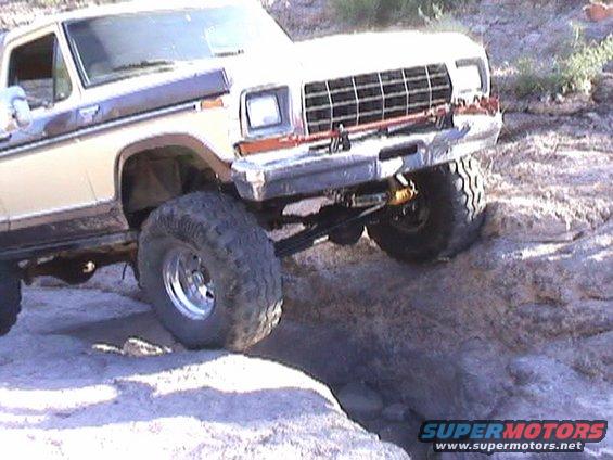 1979 Ford Bronco's front 3/4 view, tan and brown, off-roading