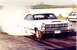 1967 Ford Fairlane - A white 1966 Ford Fairlane performs a burnout, kicking up smoke on the drag strip.